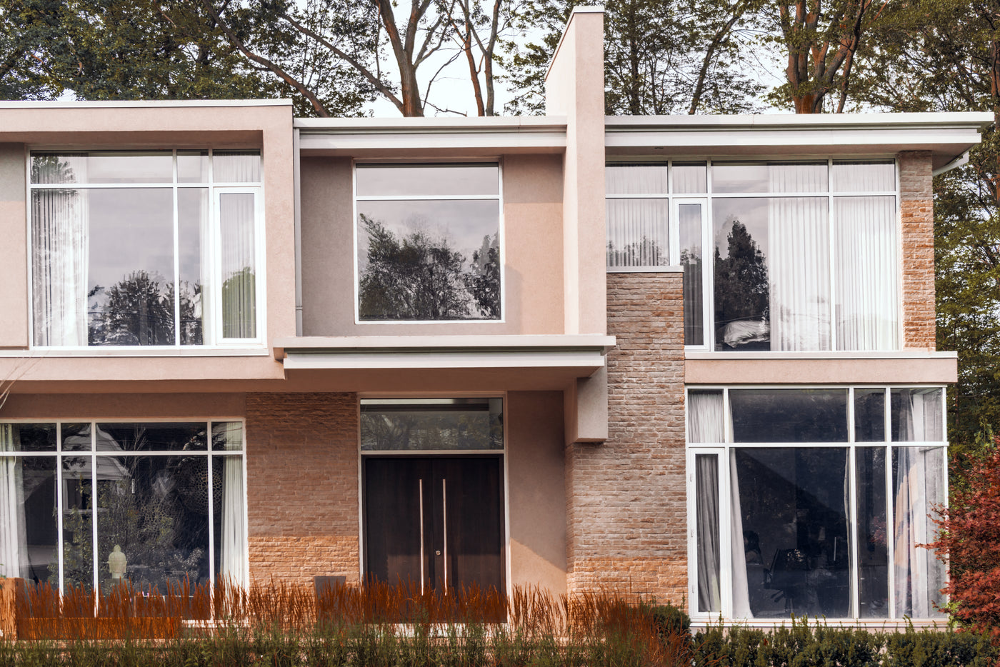 A thoughtfully designed residential home with large windows and landscaped gardens